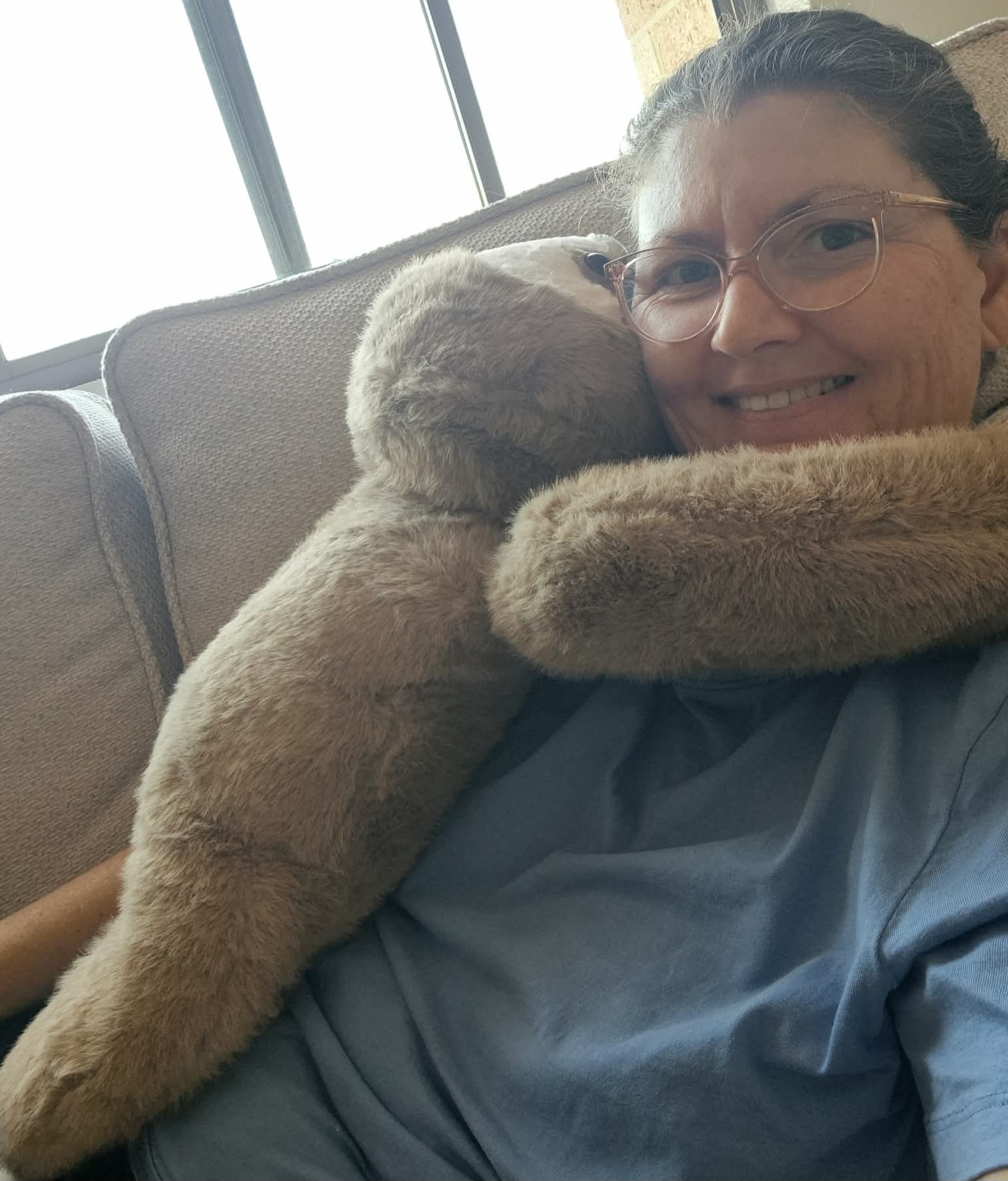 Weighted sloth resting on a book